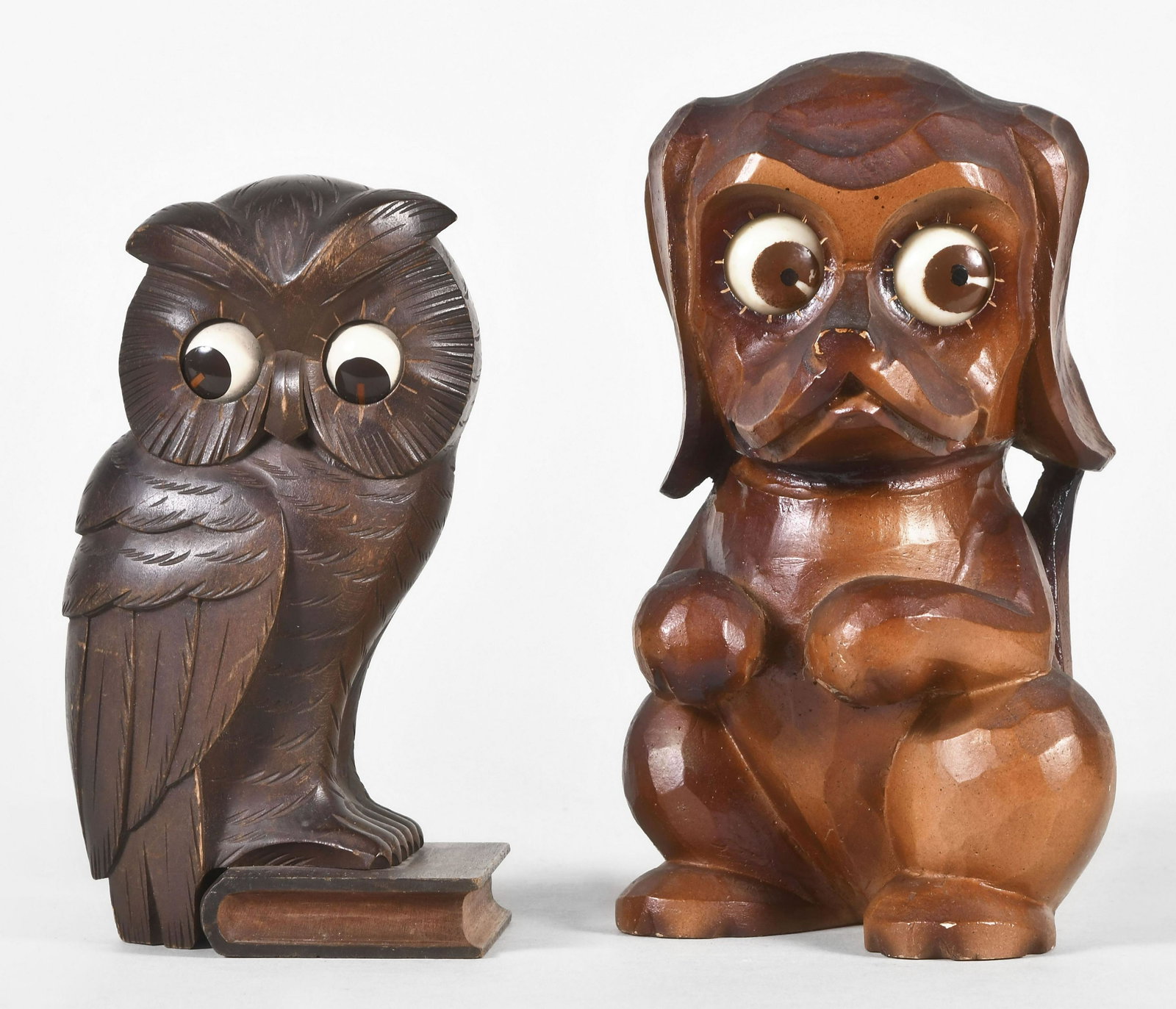 Two Oswald rotating eye clocks: 2 (Two) Oswald Uhrenfabrik, Germany rotating eye clocks, carved wood and composite cases, 30 hour, spring driven brass lever movements including an owl and a dog on haunches