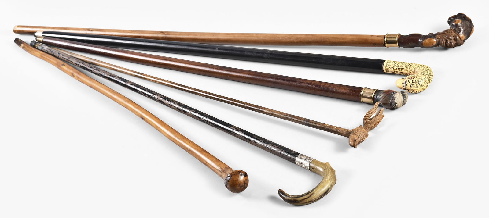 Twenty canes and walking sticks: 20 (Twenty) canes and walking sticks made from various woods including one with pool cue, one painted to simulate a snake skin, 2 commemorative canes for the Chicago Worlds fair, one of which has a gl