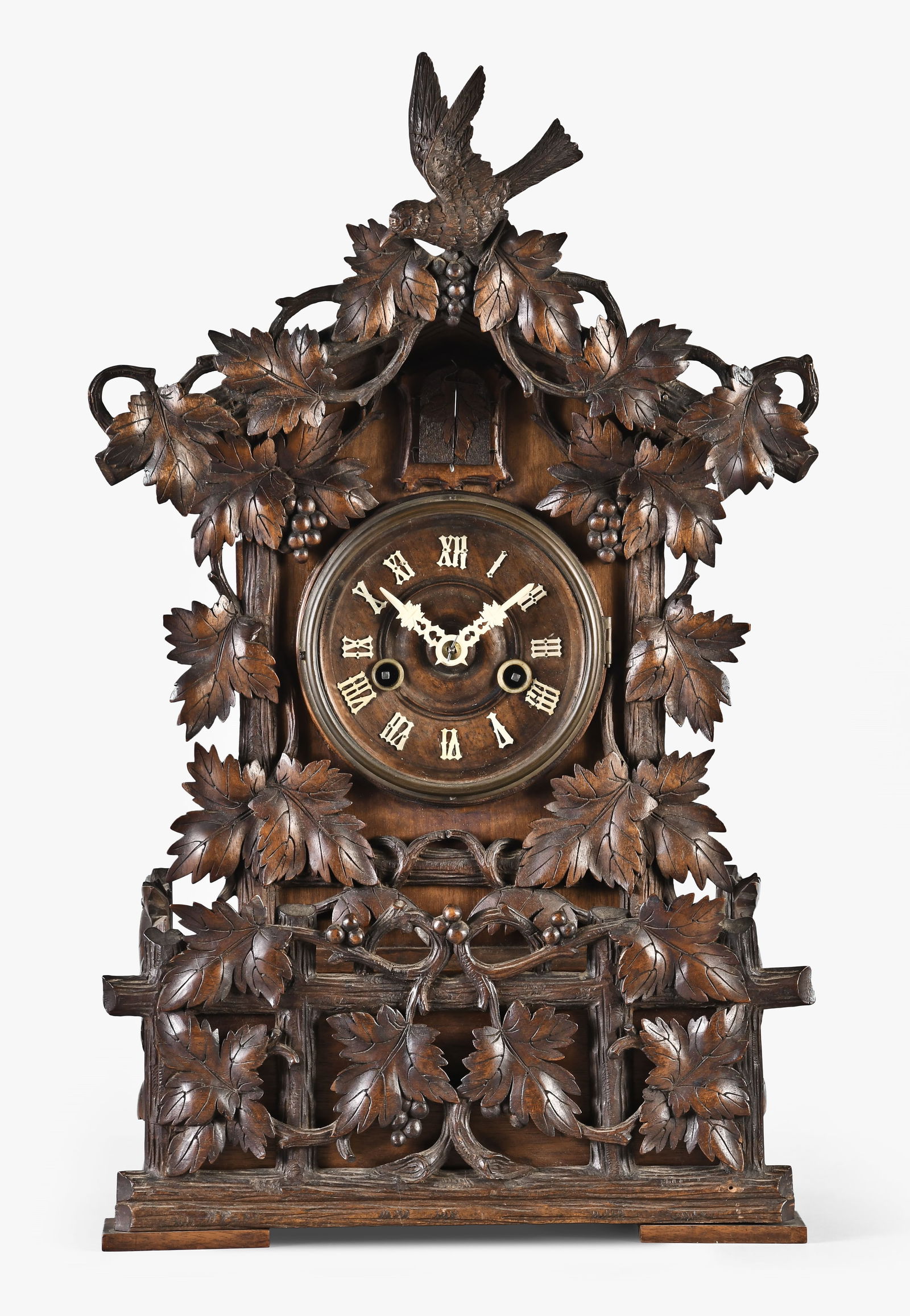 Germany, a late 19th century Black Forest shelf cuckoo and matching wall bracket: Germany, a late 19th century Black Forest shelf cuckoo with matching bracket, the case of typical cuckoo form and adorned with carved vines and leaves, the top with carved bird, and resting on a molde