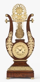 A good early 19th century French lyre form mustery clock signed Bouchet