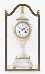 An early 20th century French marble urn form mantel clock with glass display case