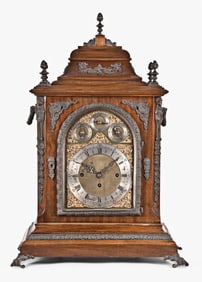 A late 19th century English three train bracket clock sounding quarters on gongs or bells