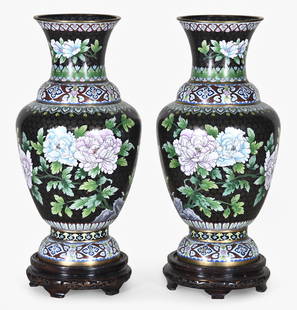 A pair of large Chinese cloisonne vases with wooden bases: A pair of large Chinese cloisonne vases with wooden bases, with large peonies, chrysanthemum, butterflies, and foliage bordered by horizontal bands of varicolored, repeating motifs, on turned, pierced
