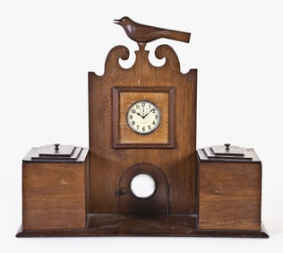An unusual early 20th century American walnut dresser box with carved bird and clock