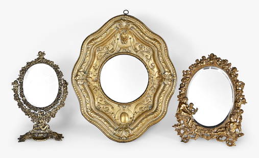 A lot of seven late 19th - early 20th century decorative brass items: 7 (Seven) late 19th - early 20th century decorative brass items including four mirrors, one cast frame ornamented with putti, another a sconce in the rococo style, one with repousse, and one with putt