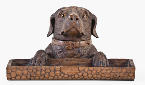 An appealing late 19th - early 20th century Black Forest carved retriever form inkstand