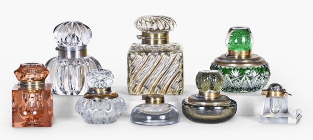A good lot of eight late 19th and early 20th century inkwells including one with Essex crystal cap