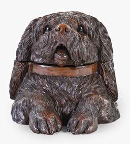 A good early 20th century Black Forest carved walnut Shih Tzu form tobacco box