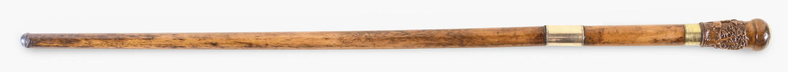 A rare commemorative cane carved from the historic Connecticut Charter Oak Tree: A rare commemorative cane carved from the historic Connecticut Charter Oak Tree, handle carved with scene of a female presenting a Native American with a sheaf of wheat, flanked by the stately Charter