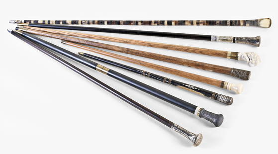 A lot of eight antique canes: 8 (Eight) antique canes including a softwood cane shaft with porcelain handle in the form of Victorian female bust, a boy's cane with an ivory handle, an ebonized shaft with threaded joint in middle a
