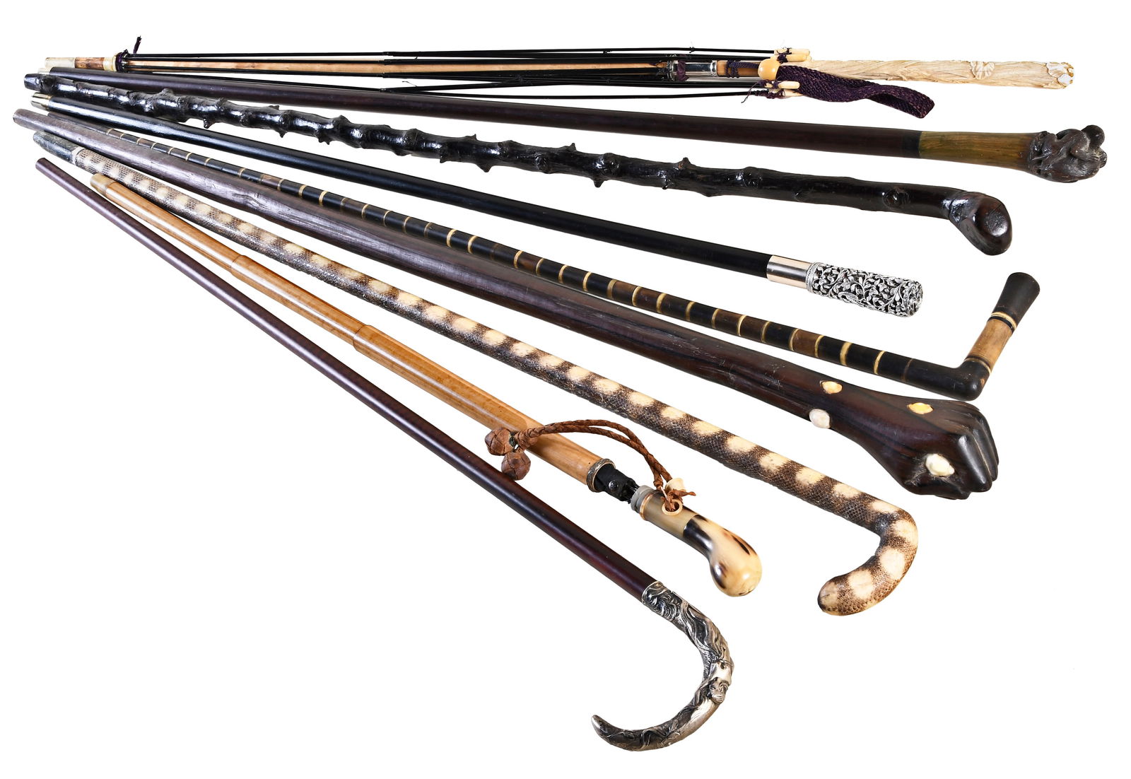 A lot of nine antique canes and umbrellas: 9 (Nine) antique canes and umbrellas including a sword cane with a fancy pewter handle, a gadget cane with umbrella, a rosewood cane with carved monkey handle, a hardwood cane with silver marked crook
