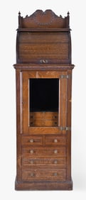 An early 20th century oak roll top dentist's cabinet