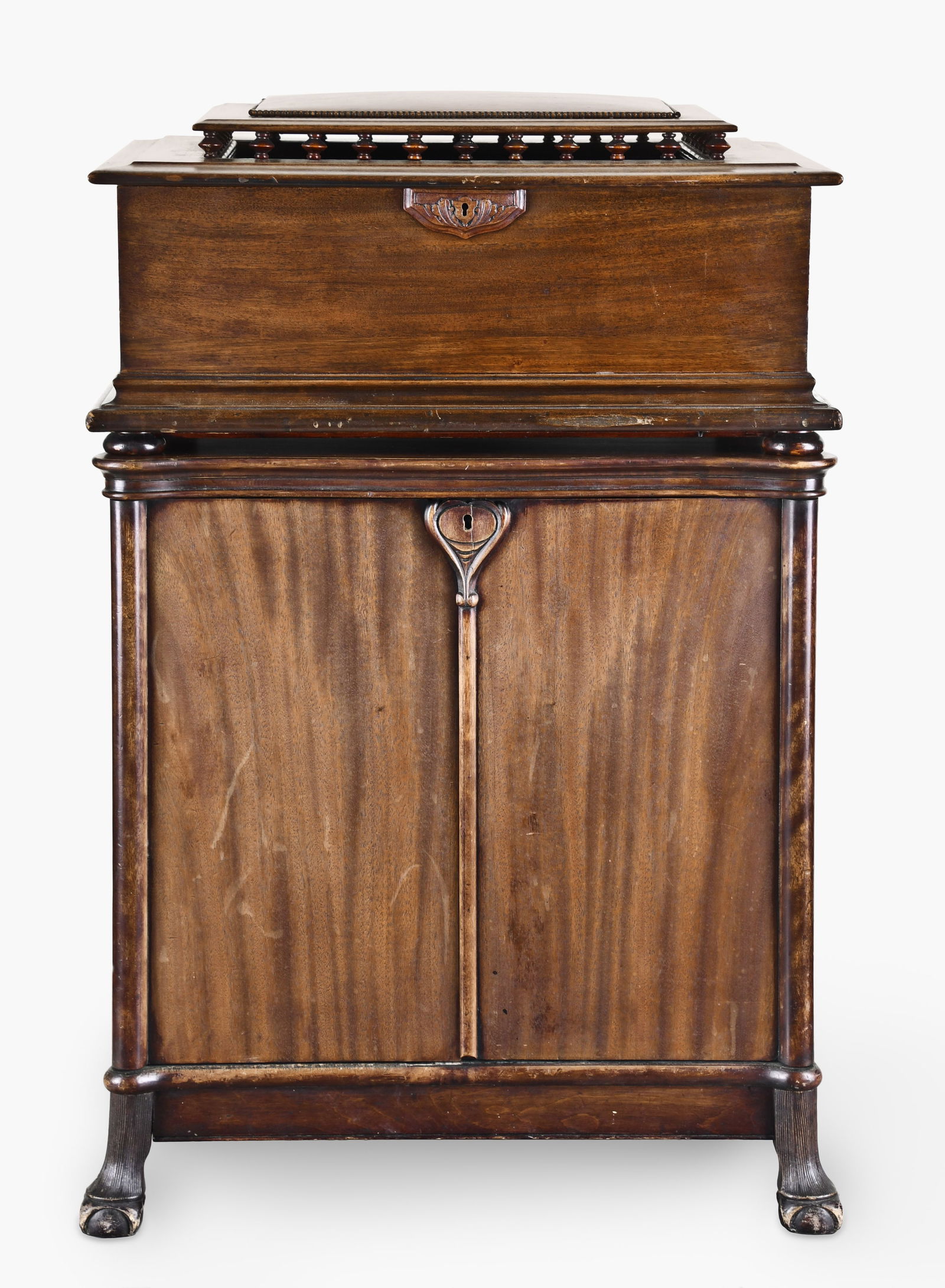 A scarce Reginaphone 20 3/4 inch disc music box with phonograph and cabinet: The Regina Co., Rahway, N.J., a scarce "Reginaphone" 20 3/4 inch disc music box with phonograph, mahogany case with molded base, front with carved wooden escutcheon, the lid with molded edge, and balu