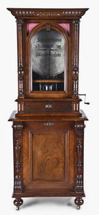 A Polyphon Model 104 music box: Polyphon Musicwerk, Leipzig, Germany, "Model 104" floor standing, coin operated disc music box, playing 19-5/8 inch discs, robust dual comb movement starting upon insertion of a coin, the case of mixe
