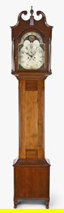 A Pennsylvania tall clock: A tall clock attributed to an unknown Pennsylvania maker in a solid light colored hardwood case, possibly cherry, scroll top with a single wooden finial surmounting a reeded plinth, plain turn columns