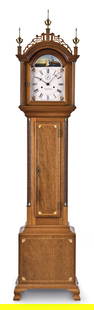A Foster Campos grandmother clock: Foster Campos, Pembroke, Mass., grandmother clock in a mahogany case with satinwood and ebony cross banded inlay, fretwork crest on hood surmounted by reeded plinths with brass finials and flanked by
