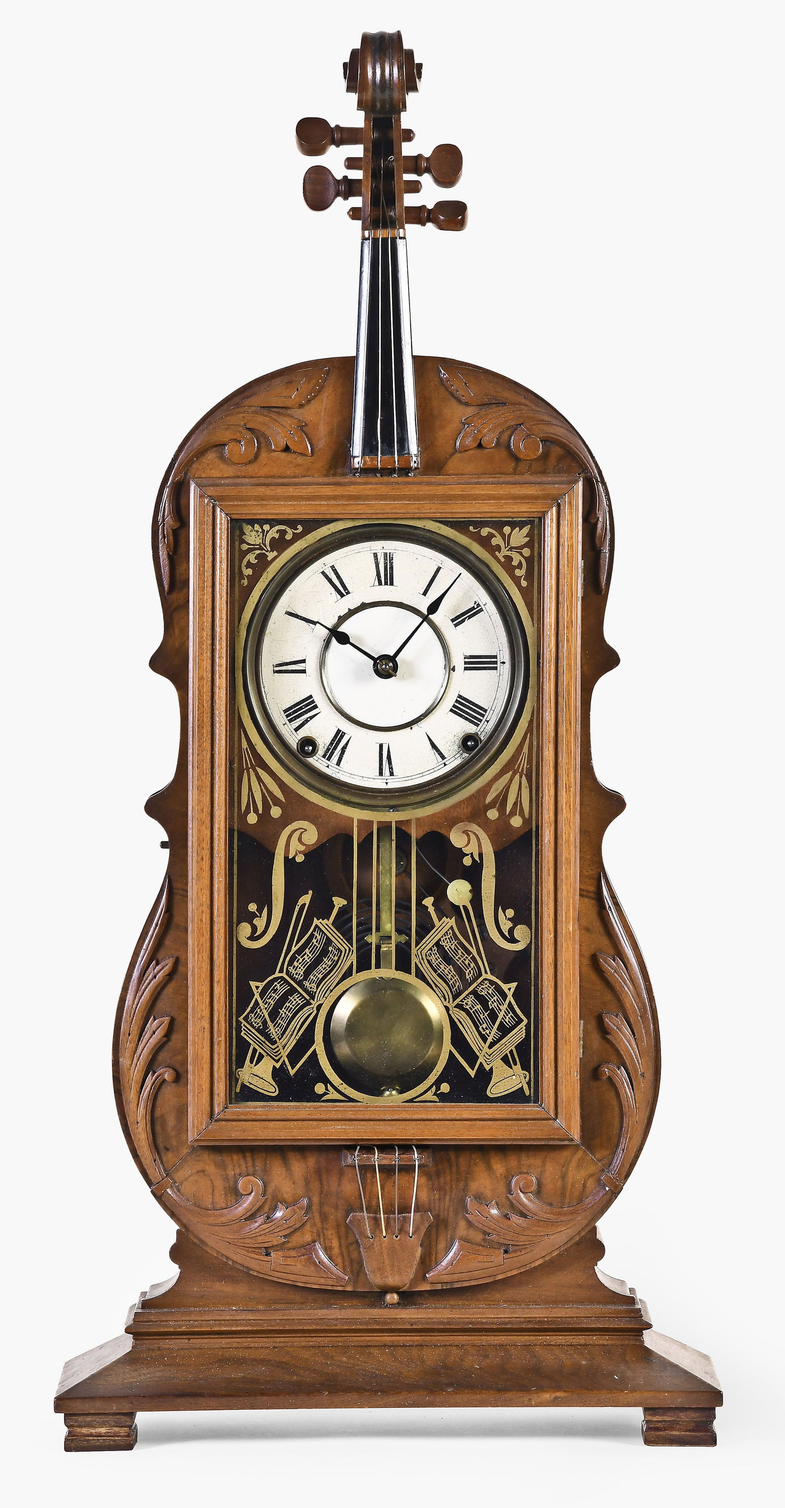 A rare Seth Thomas Violin mantel clock: Seth Thomas Clock Co., Thomaston, Connecticut, rare "Violin" form mantel clock, walnut case with applied carvings, 5.5-inch painted Roman numeral dial, eight-day, spring driven time and strike spring