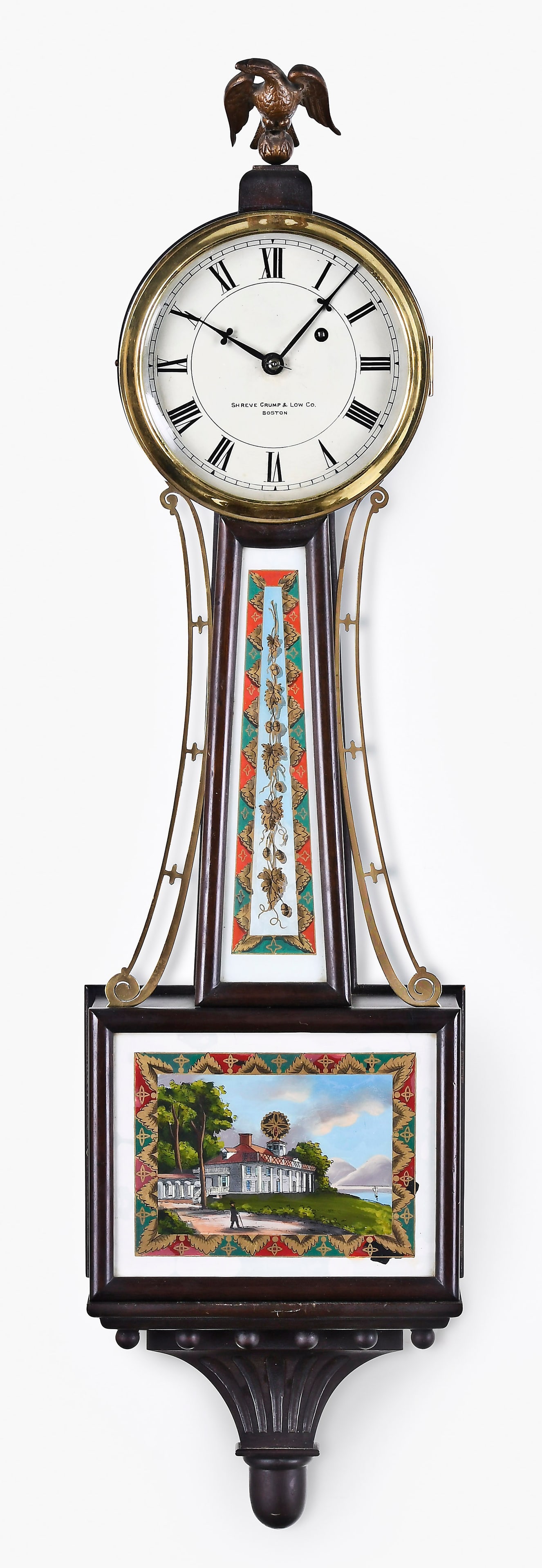 A Herschede Clock Co. banjo clock: Herschede Clock Co., Cincinnati, Ohio retailed by Shreve, Crump and Low, Boston, patent timepiece or banjo clock, mahogany and mahogany veneered case, painted metal dial, spear form hands, eight day,