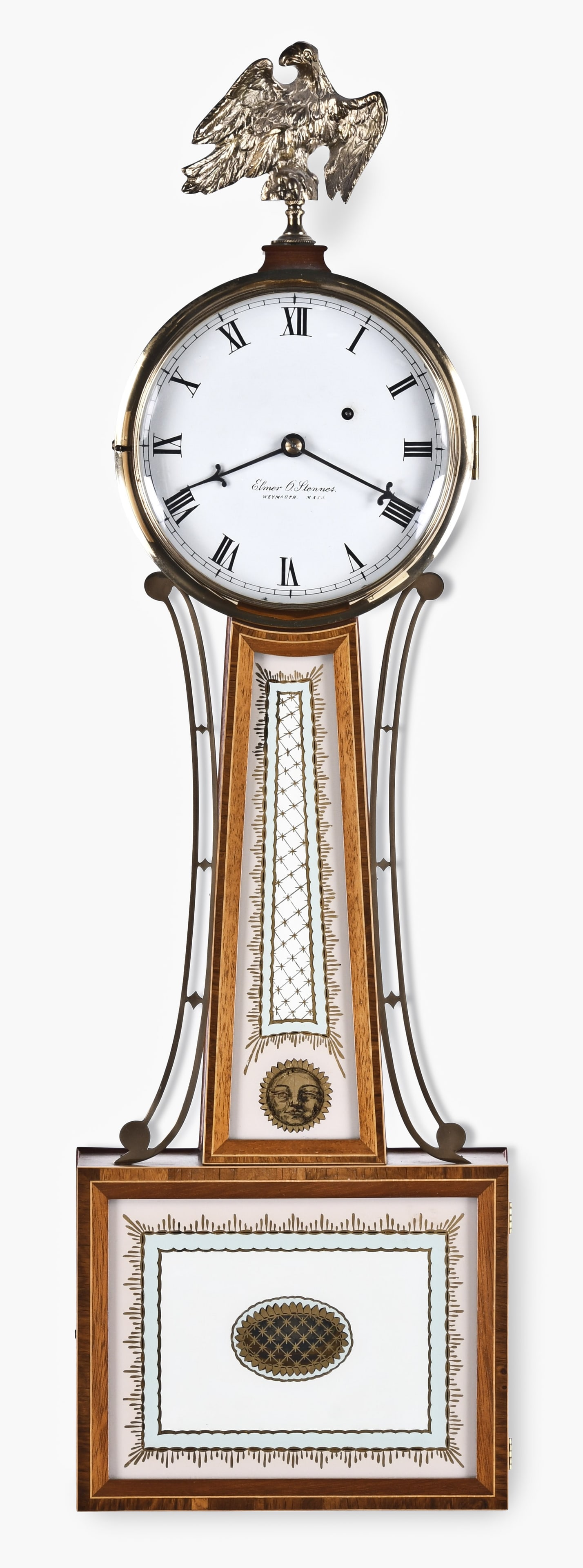 An Elmer Stennes patent timepiece or banjo clock: Elmer O. Stennes, Weymouth, Mass., patent timepiece or banjo clock, banded mahogany case, Willard style tablets, roman numeral painted metal dial, banjo type hands, eight day, weight driven brass move