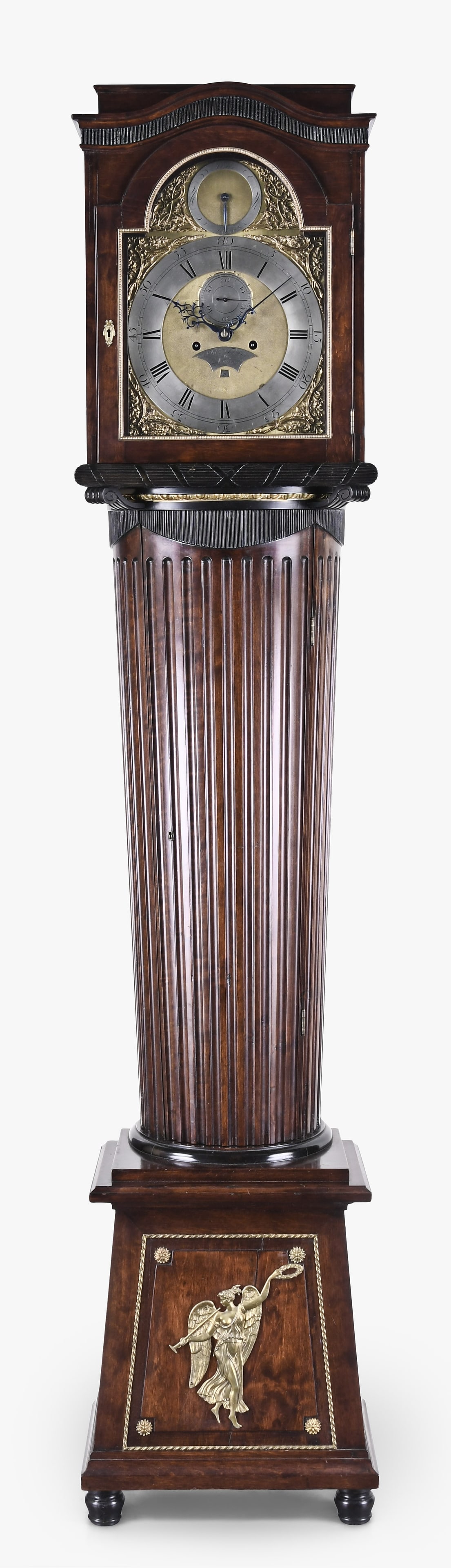 An unusual late 18th century English tall clock signed John Taylor London: John Taylor, London, an unusual late 18th century tall clock, the hardwood case on turned feet and with paneled, trapezoidal base having gilt mounts, below a fluted trunk of Minoan column form with eb