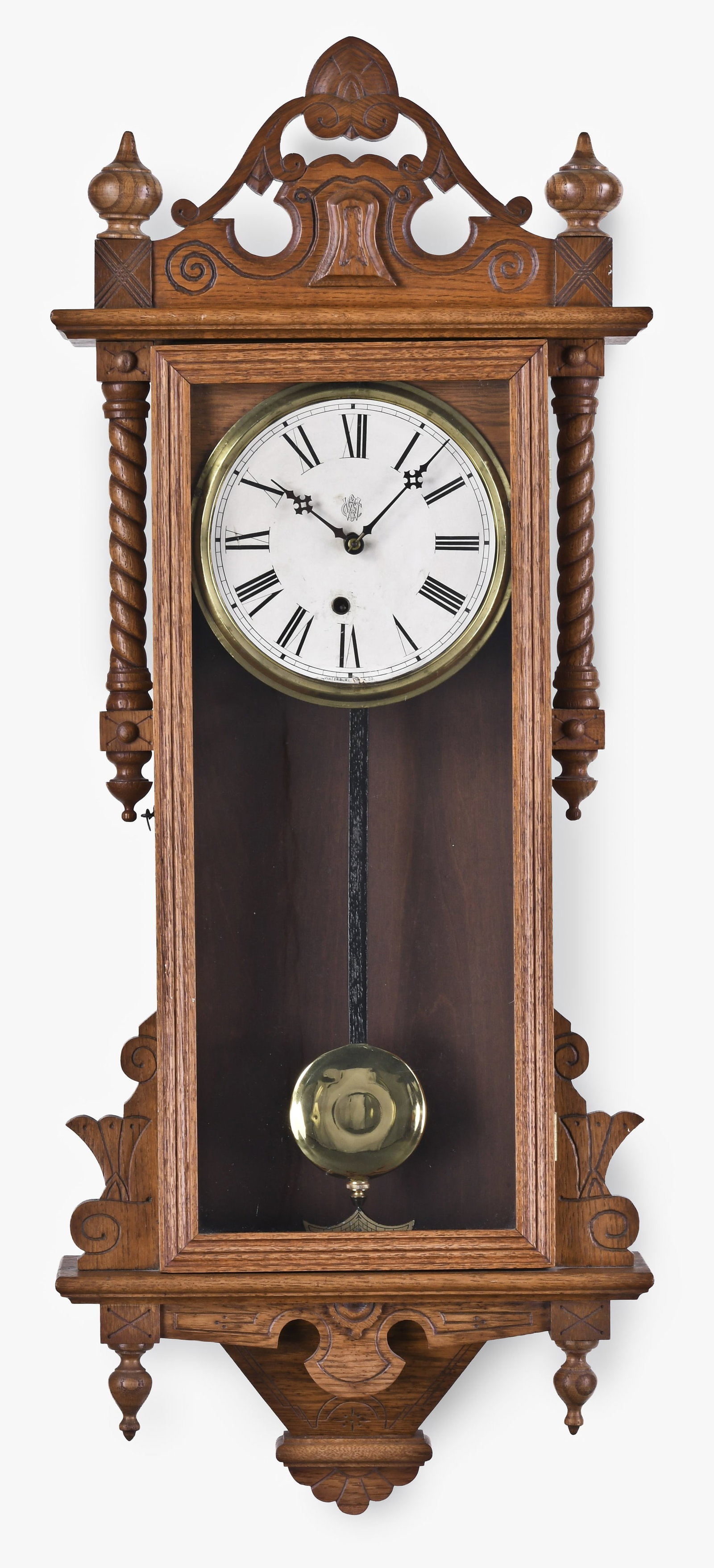 A Waterbury Clock Co. Elgin oak wall clock: Waterbury Clock Co., Waterbury, Conn., "Elgin" wall clock in an oak case, paper roman numeral dial, eight day, time only, spring driven movement, c1893