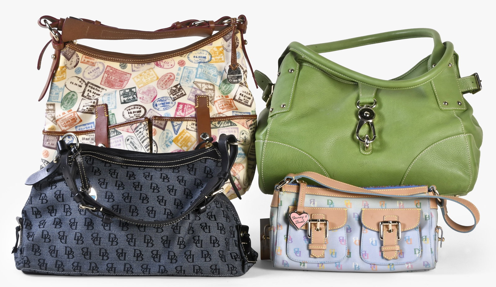 A lot of four late 20th - early 21st century Dooney & Bourke bags: 4 (Four) late 20th - early 21st century Dooney & Bourke bags, including a denim shoulder bag with "DB" anniversary print, a large passport-stamp print zip top bag, a rainbow zip top bag with multicolo