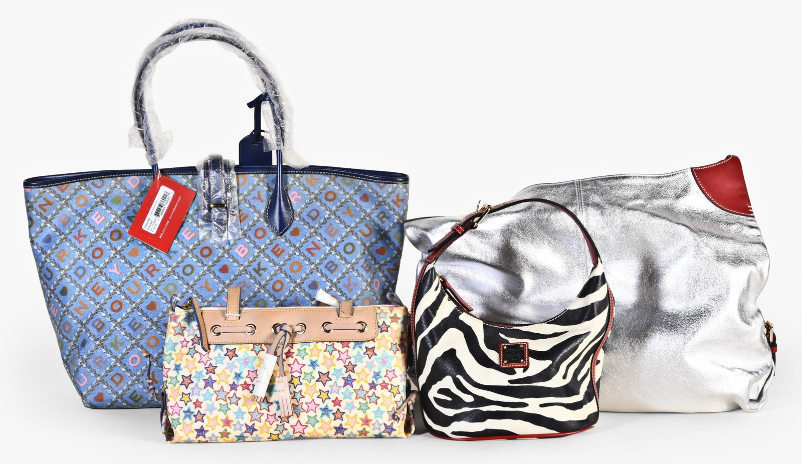 A lot of four late 20th - early 21st century Dooney & Bourke bags: 4 (Four) late 20th - early 21st century Dooney & Bourke bags, including a large tote with "Dooney & Bourke" spelled out in repeating diagonals across the surface, with sales tag and protective wrap, a