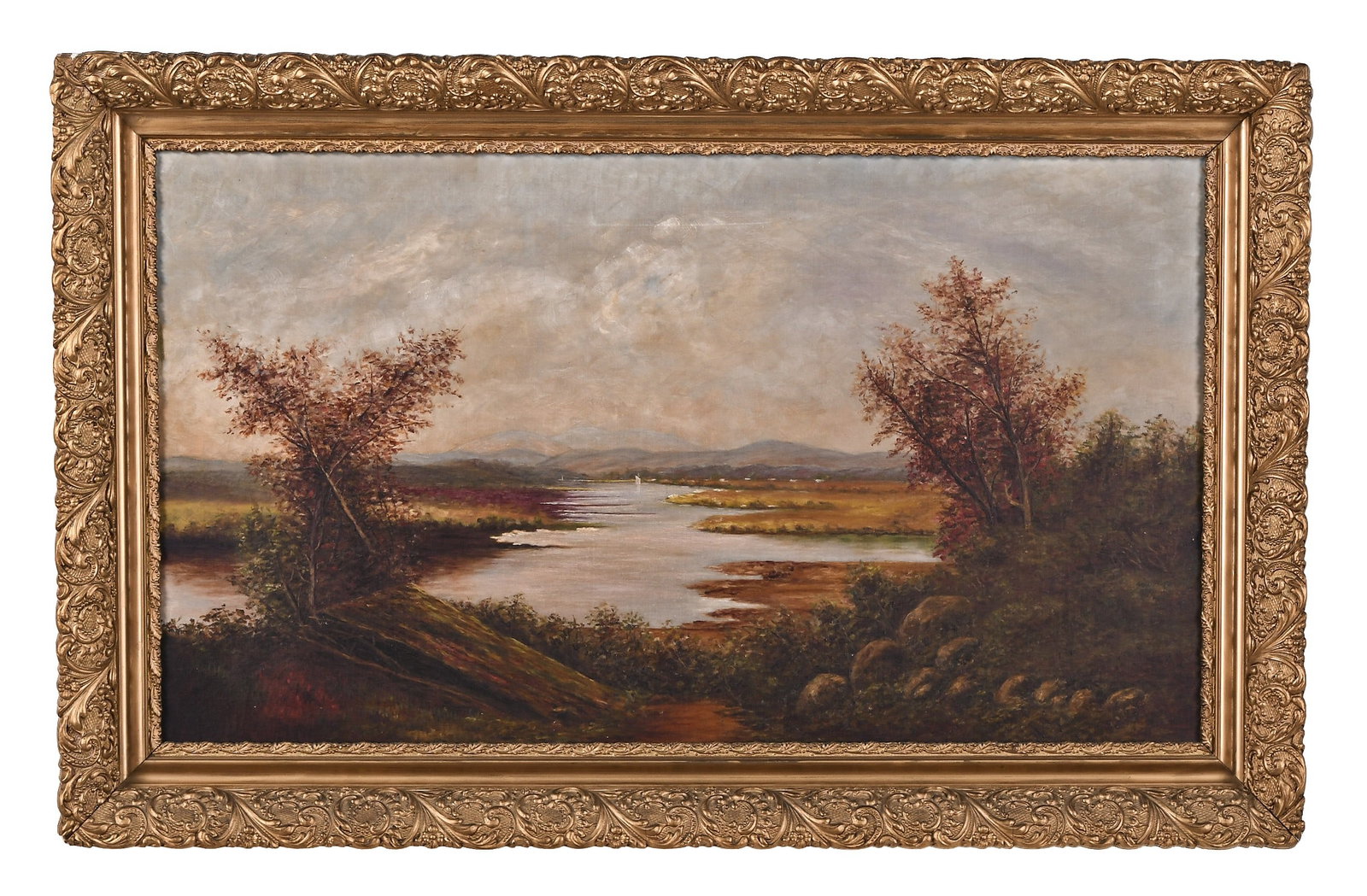 A large late 19th - early 20th century American School oil on canvas landscape: A large late 19th - early 20th century oil on canvas landscape, the foreground with rocks and trees leading to a marsh with sailboat and mountains in the background, the foliage on the shore in autumn