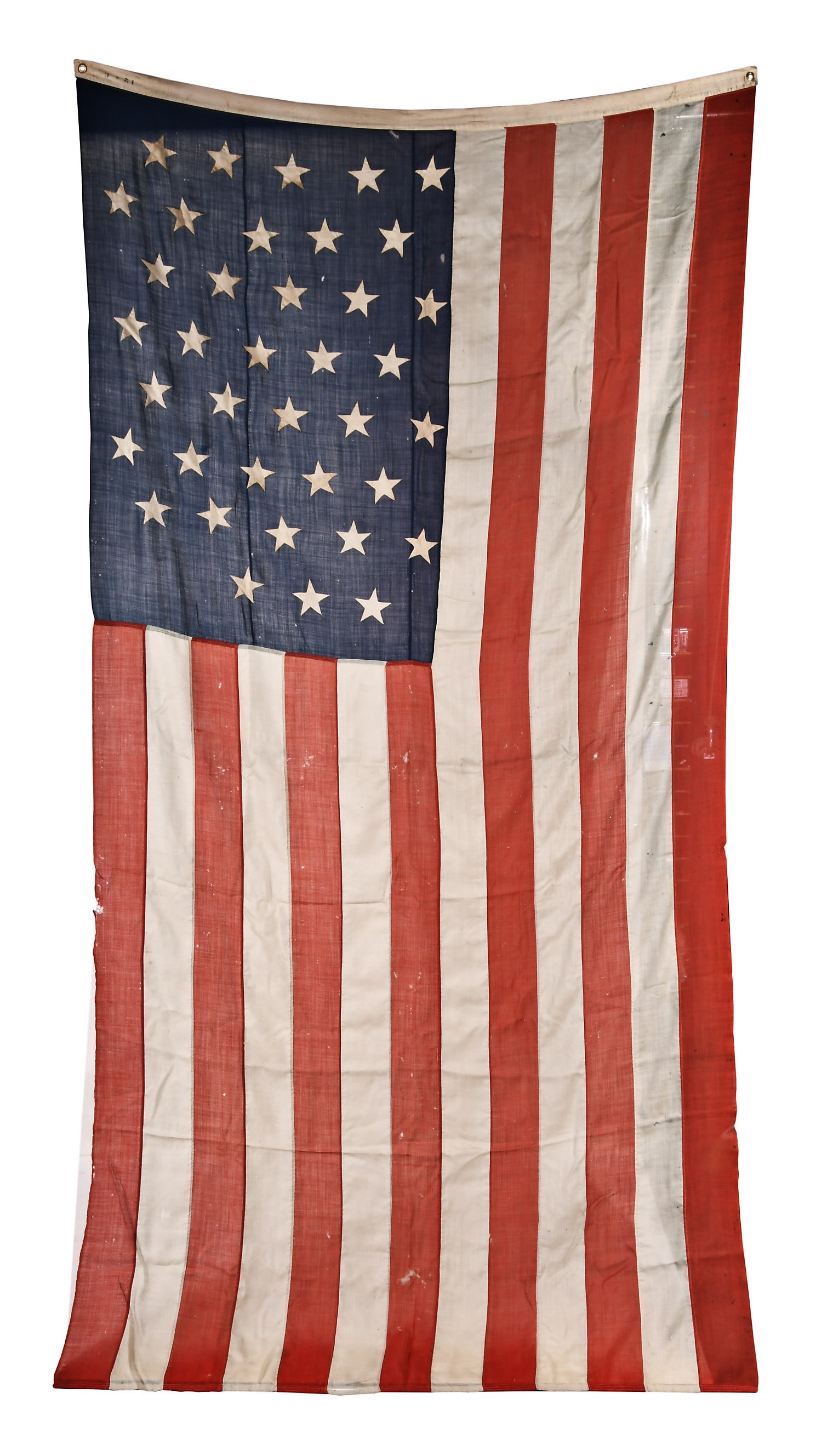 A large late 19th century American 38 star Centennial flag: A large late 19th century American 38 star Centennial flag, 72 x 144 inches, loosely woven wool, with stars arranged in staggered, vertical lines, and hand stitched to the blue field, with machine sti