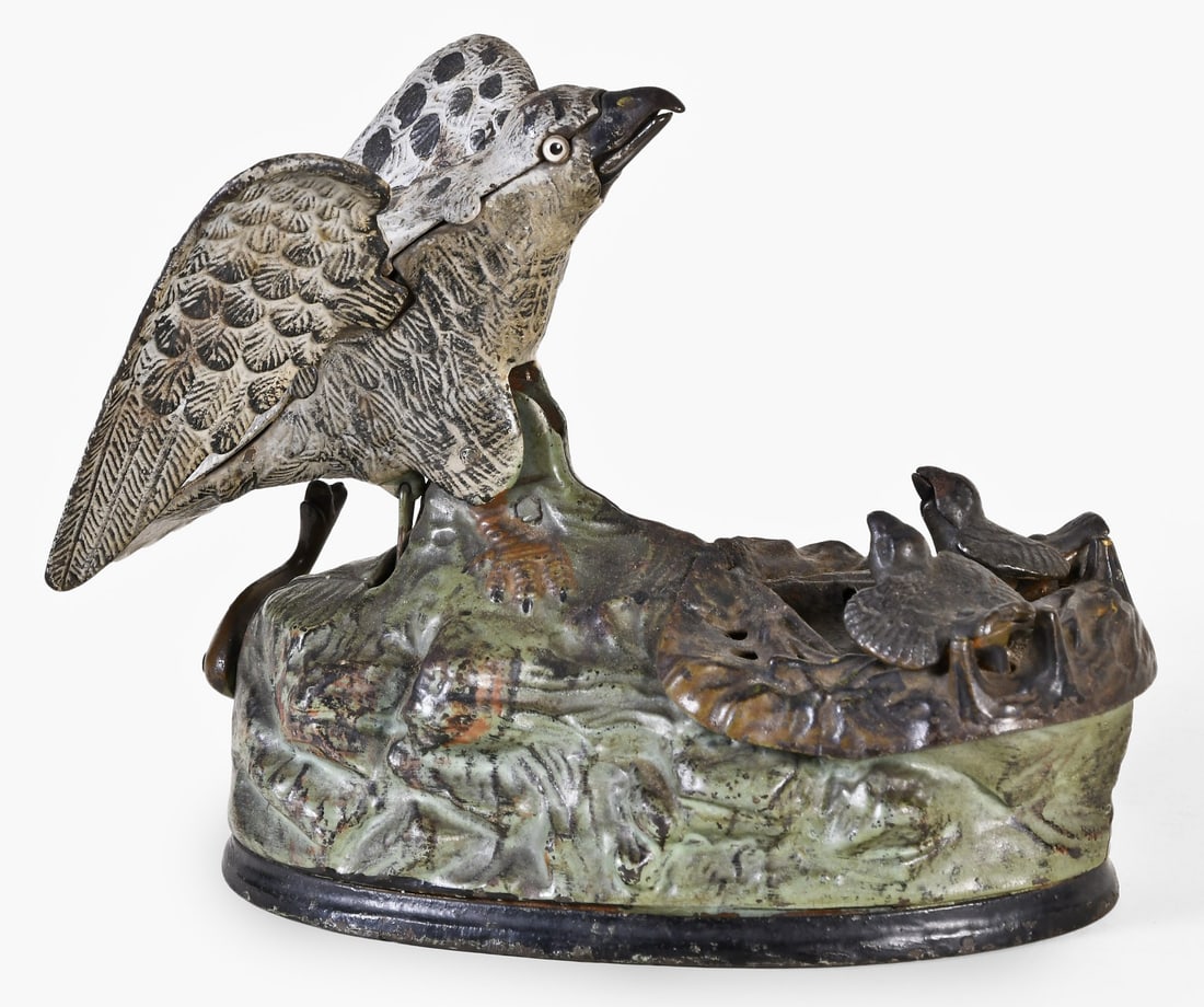 A late 19th century J. & E. Stevens cast iron Eagle and Eaglets mechanical bank: J. & E. Stevens Co., Cromwell, Conn., a late 19th century "Eagle and Eaglets" mechanical bank, painted cast iron, the eagle with glass eyes and interior of base with squeaker, pressing the lever cause