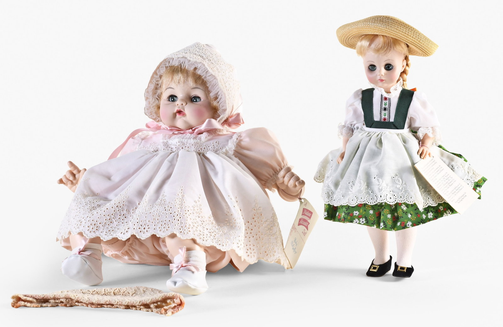 A lot of two mid 20th century Madame Alexander dolls in their original boxes: 2 (Two) Madame Alexander dolls in their original packaging, the first a No. 1580 "Heidi", the 13 inch plastic doll with blue sleep eyes, blond wig, and straw hat, jointed body, and dirndl with floral 