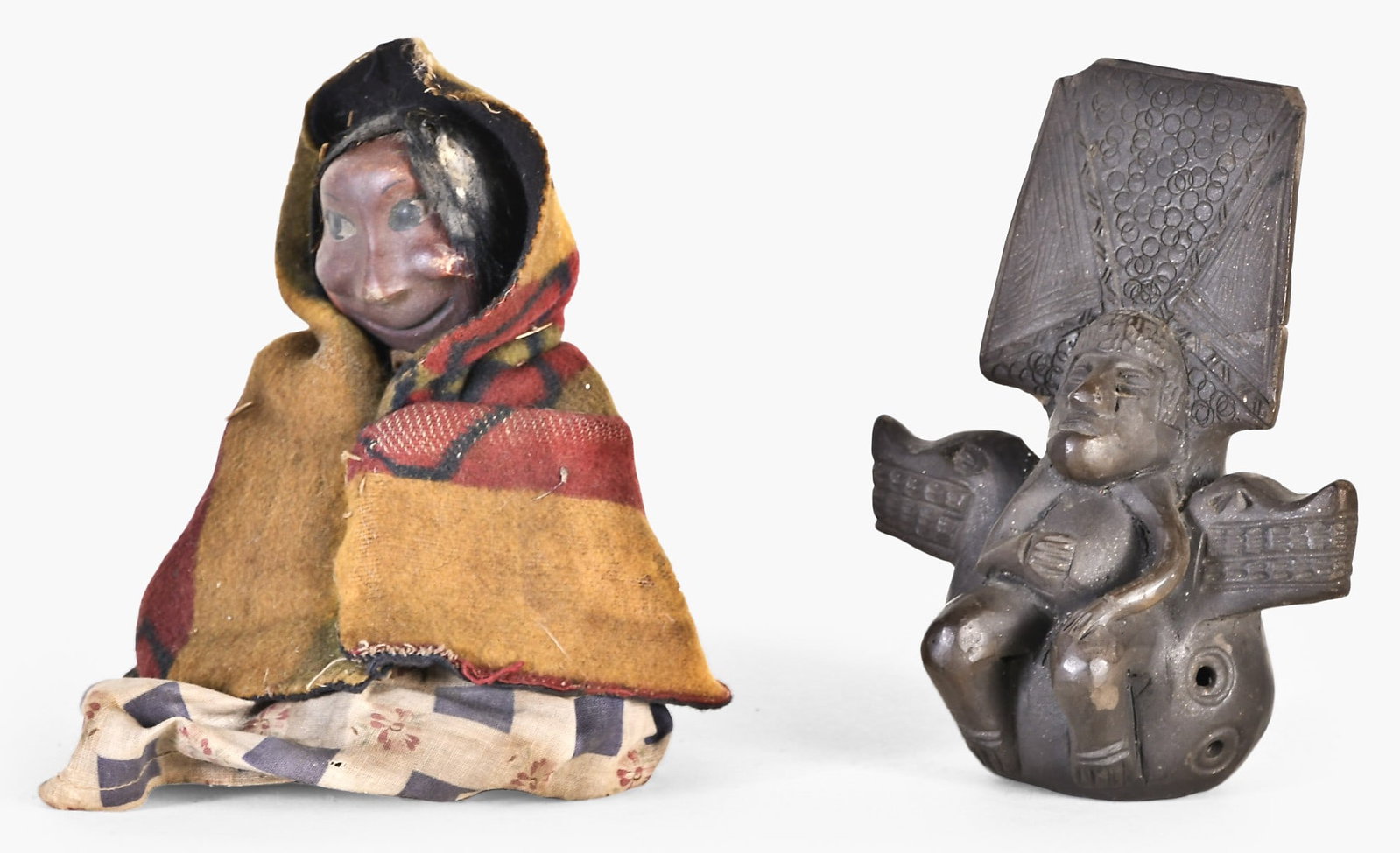 A pre Columbian Tairona effigy ocarina and an early 20th century Skookum doll: 2 (Two) disparate objects, the first a pre Columbian Tairona effigy ocarina, the figure with tall headdress and seated on a two headed serpent throne, the other an early 20th century Skookum type doll