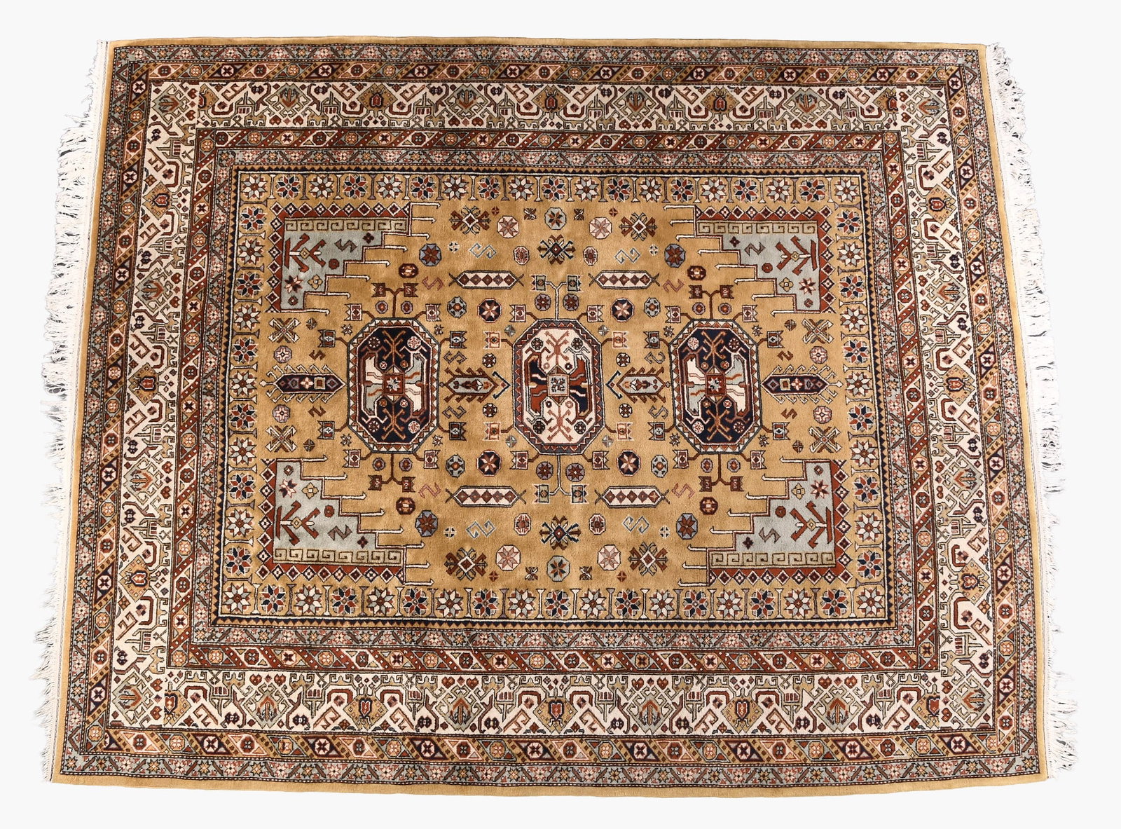 A large 20th century Turkish style rug: A large 20th century Turkish style rug, five band border with gold, white and red grounds surrounding a gold field, all areas with various repeating geometric and stylized floral patterns