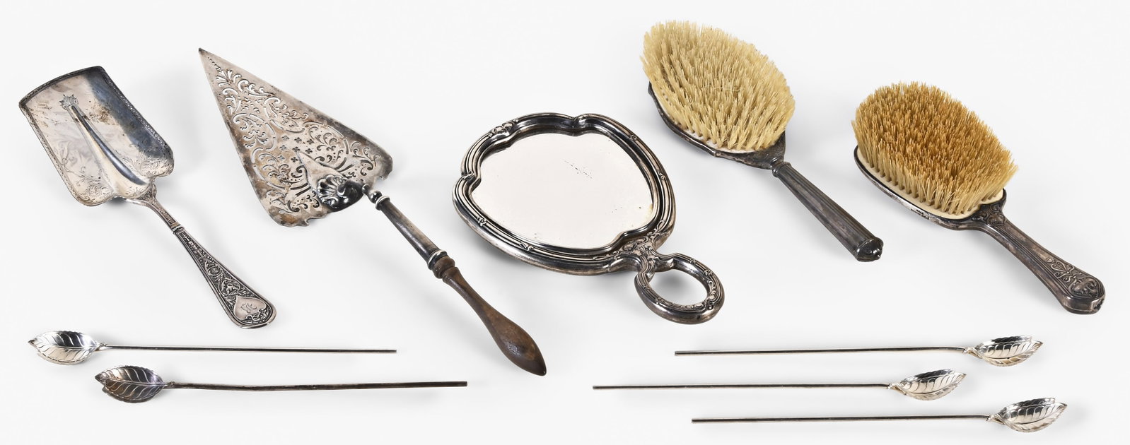 A lot of sterling silver items including five Tiffany & Co. iced tea spoons: A lot of sterling silver items including five Tiffany & Co. iced tea spoon/ straws, two brushes and a hand mirror, an engraved serving shovel or scoop, and a pierced pie server of unknown purity with 