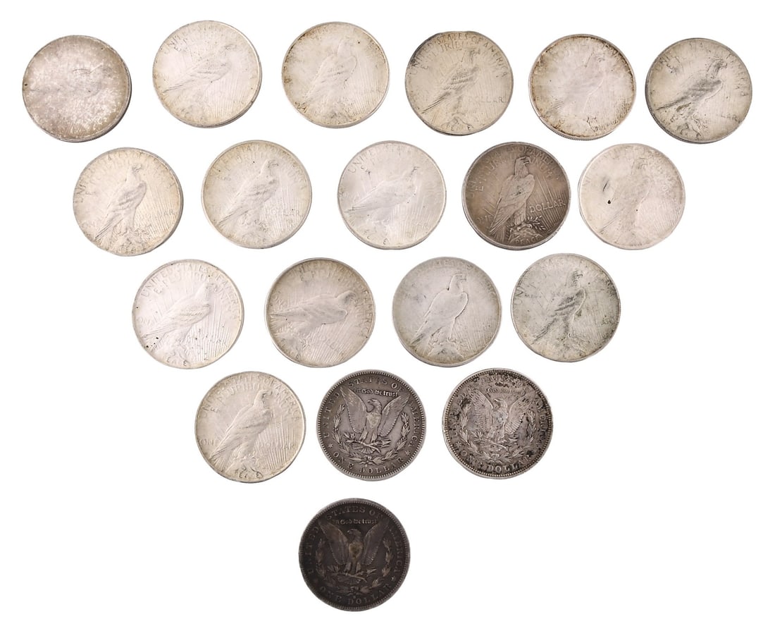 A lot of nineteen silver dollars: Nineteen (19) silver dollars, consisting of sixteen Peace silver dollars; one 1921, ten 1922, three 1923, one 1927, and one 1928 together with three Morgan dollars dated 1879, 1882, and 1921.