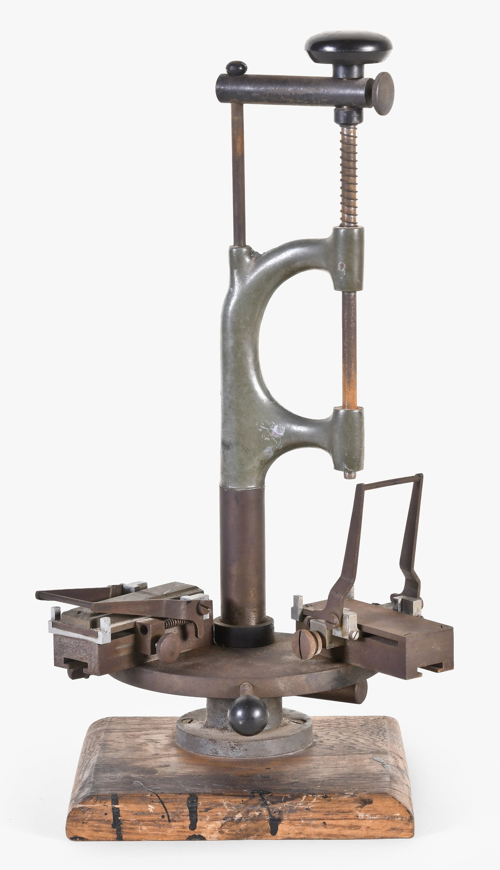 A mid 20th century Swiss watch dial printing tool: Switzerland, a mid 20th century watch dial printing tool, of cast iron and steel construction, and mounted to a hardwood base