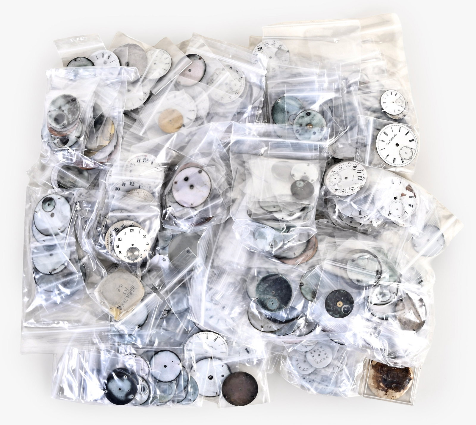 A large lot of American and Swiss enamel and metal wrist and pocket watch dials: A large lot of American and Swiss enamel and metal wrist and pocket watch dials, makers including Hampden, Elgin, Illinois, Waltham, Rockford, Hamilton, and others