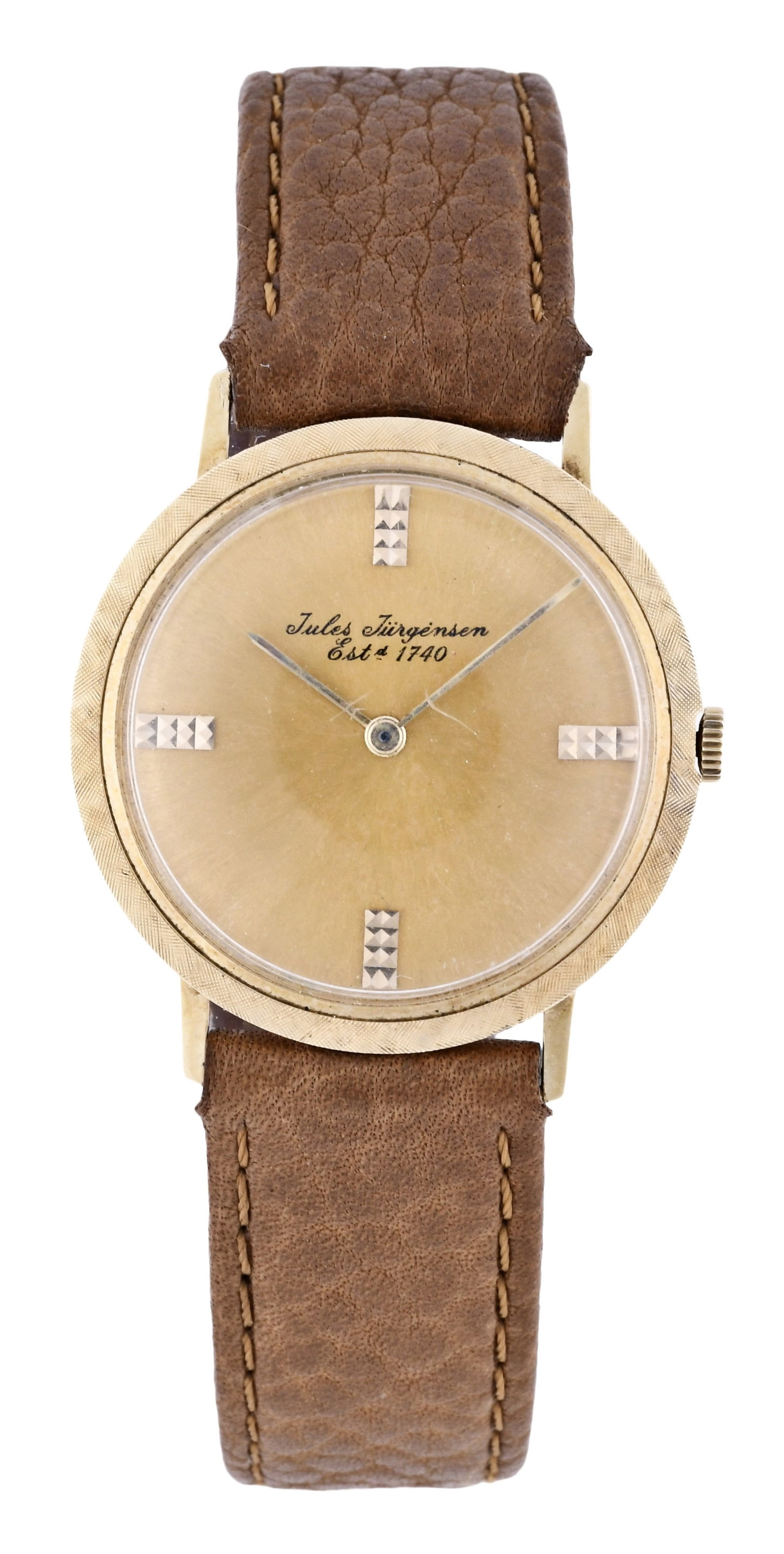 A Jules Jurgensen 14 karat wrist watch: Jules Jurgensen, Switzerland, 14 karat yellow gold round case with Florentine finished bezel, brown leather strap, original champagne dial with applied gold hobnail indices and gold baton hands, 17 je