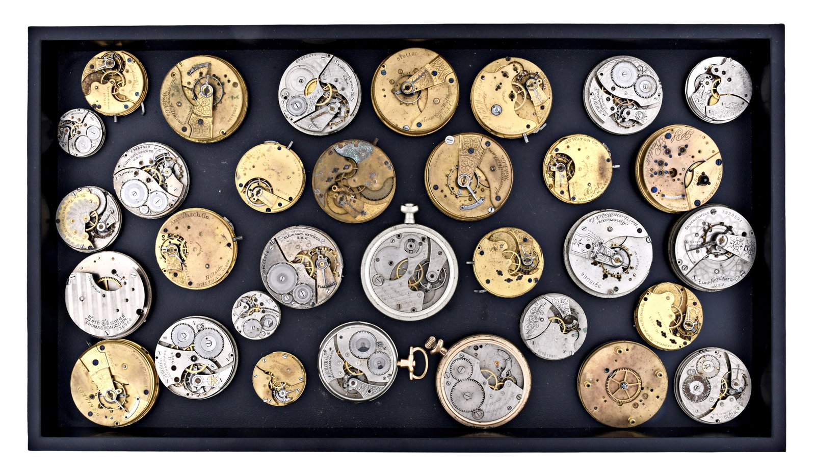 A lot of American pocket and wrist watch movements: A lot of American pocket watch movements, 18 - 6/0 size, 7 - 17 jewel gilt and nickel plate movements, makers including Waltham, Hamilton, Hampden, Elgin, Seth Thomas, and others