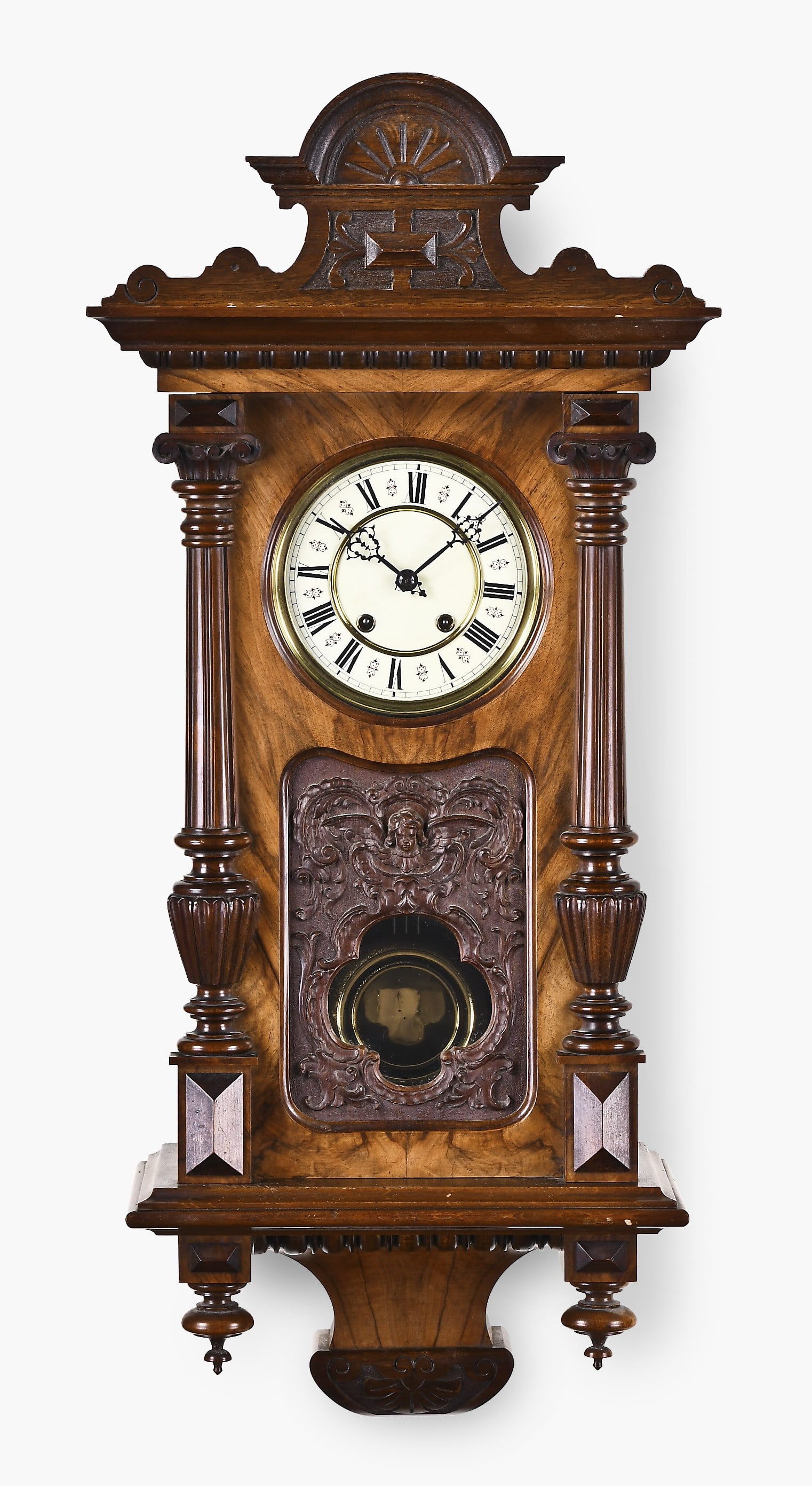 An Uhrenfabrik Mueller & Co. Vienna style regulator: Uhrenfabrik Mueller & Co., Muehlheim, Germany, Vienna style regulator in Alt Deutsch walnut veneered case with turned half columns and carved door panel featuring angelic figure with aperture for
