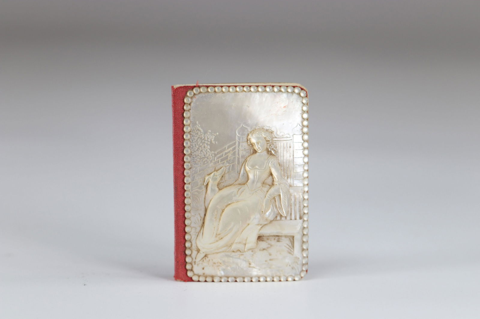Carved mother-of-pearl ball book of a young woman with (1 of 3)