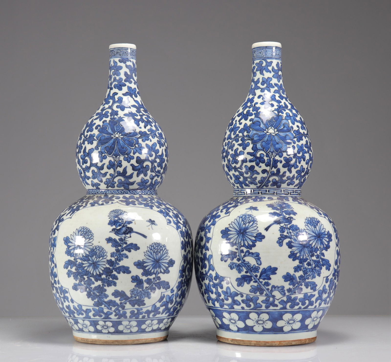 Pair of double-gourd vases in blue-white enamelled porcelain decorated with floriform medallions of (1 of 5)