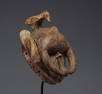 Ibo Nigeria mask in carved wood surmounted by a bird