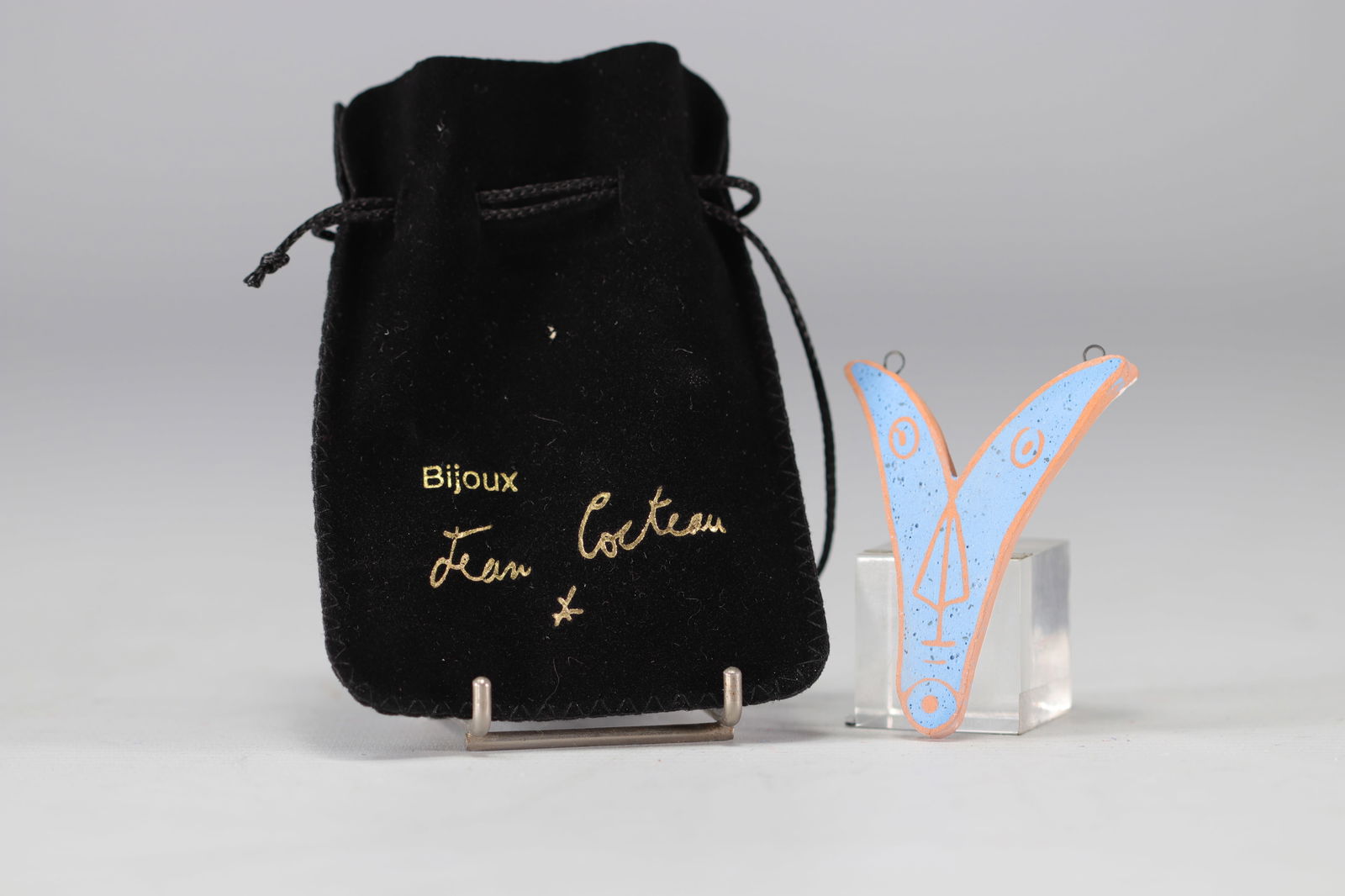 Jean Cocteau (1889-1963).  1958-1959.  "Ve" 4th Variant.  V-shaped pendant in white and blue clay. (1 of 2)