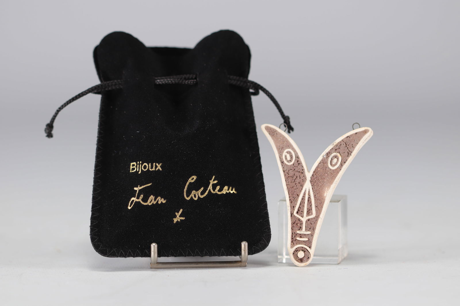 Jean Cocteau (1889-1963).  1958-1959.  "Ve" 5th Variant.  V-shaped pendant in white and brown inlaid (1 of 2)