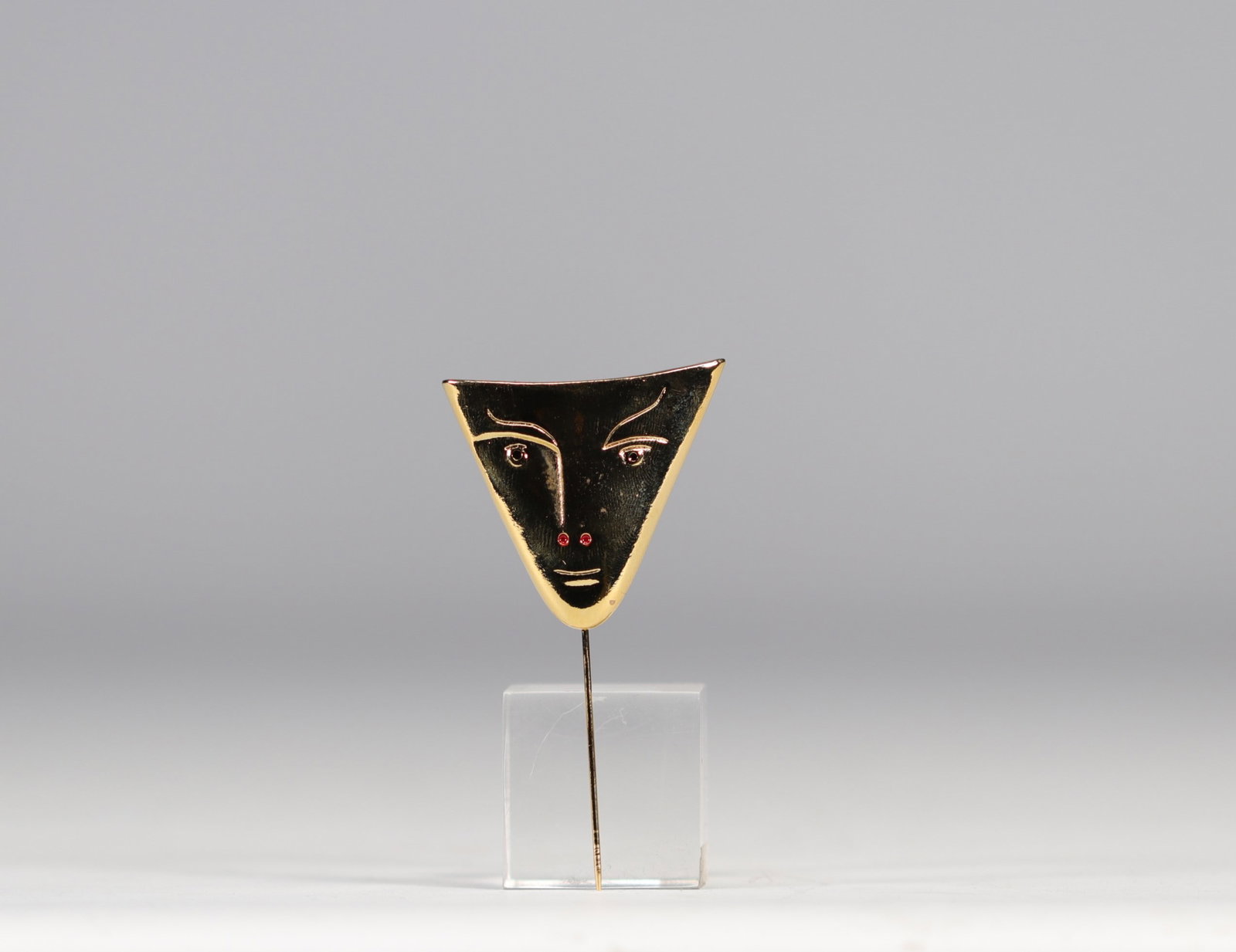 Jean Cocteau.  "Face triangle".  Bronze polished and gilded with fine gold, red enamel. Eyes: (1 of 2)