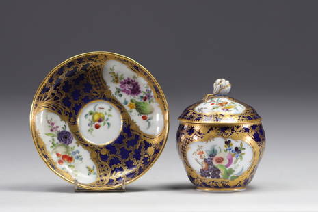 MARCOLINI, Sugar bowl in Meissen porcelain.: MARCOLINI, Meissen porcelain sugar bowl and saucer in shades of blue enhanced with scrolls and ormolu rose, fruit and flowers. Fretel in the shape of a rosebud enhanced with gold. Mark B F and swords