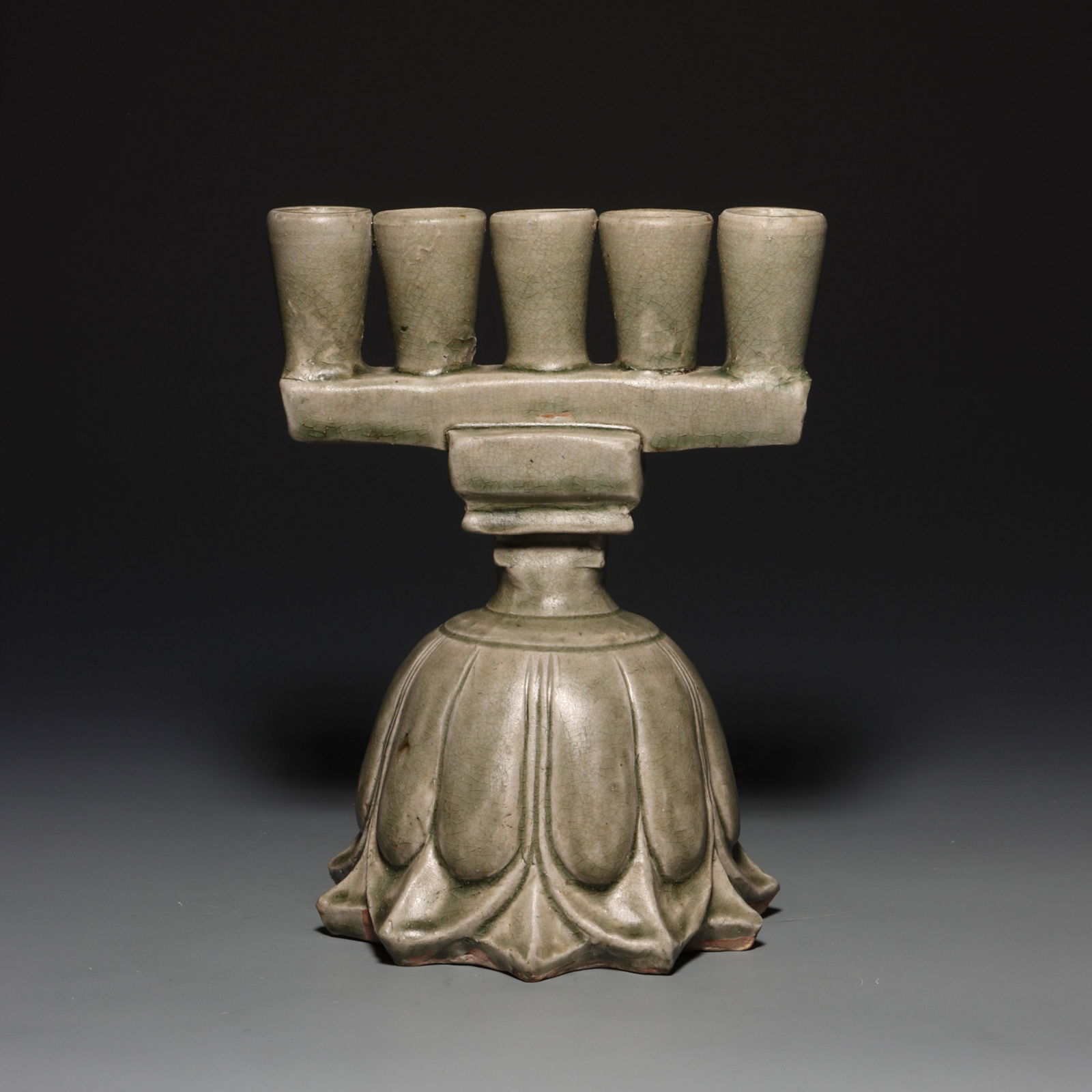 CHINESE TANG DYNASTY CELADON CANDLESTICK WITH LOTUS PETAL PATTERN: CHINESE TANG DYNASTY CELADON CANDLESTICK WITH LOTUS PETAL PATTERN ; H. 22 cm.W. 17 cm.