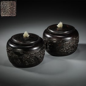 A pair of Chinese Qing Dynasty red sandalwood go jars with ingenious carvings of figures and stories
