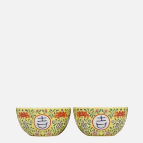 A pair of yellow-glazed and famille rose floral cups from the Qianlong period of the Qing Dynasty,